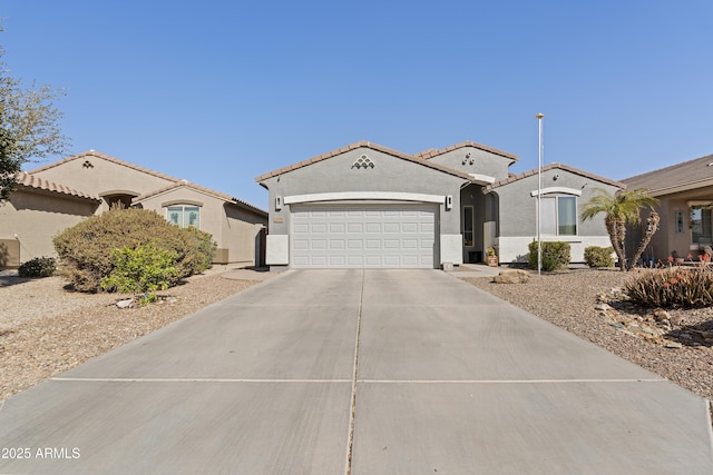 mediterranean / spanish-style house featuring driveway, a tile roof, a garage, and stucco siding