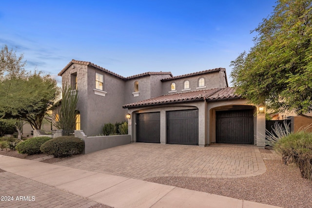 mediterranean / spanish-style house featuring a garage