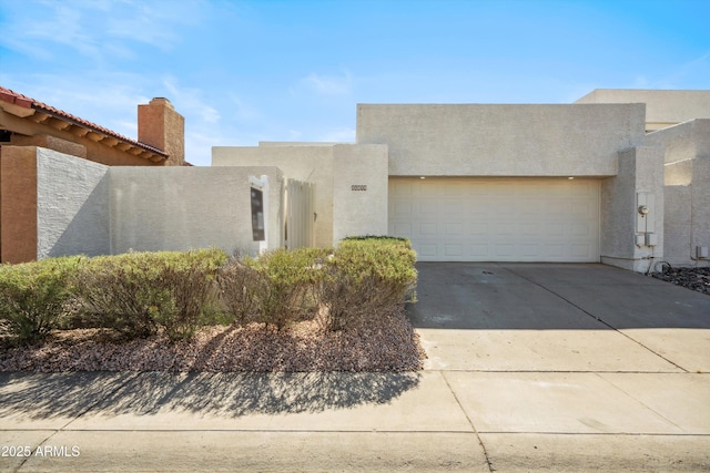 11079 N 110th Pl, Scottsdale, AZ 85259 - adobe home with stucco siding, an attached garage, driveway, and a chimney