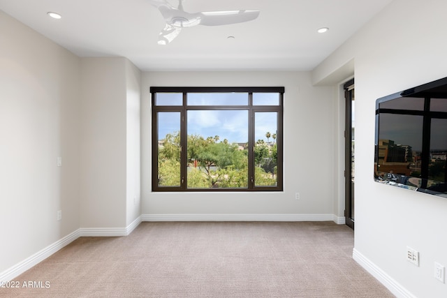 carpeted empty room featuring ceiling fan