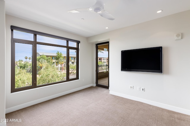 unfurnished room with light carpet and ceiling fan