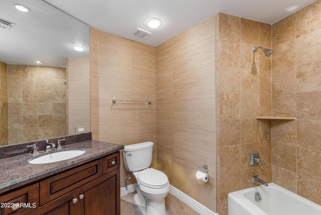 full bathroom with vanity, tile patterned floors, toilet, and tiled shower / bath