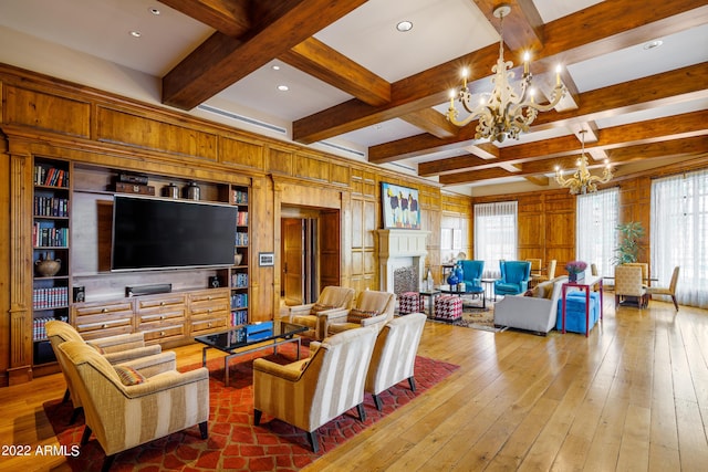 living room featuring beamed ceiling, coffered ceiling, a chandelier, and hardwood / wood-style floors