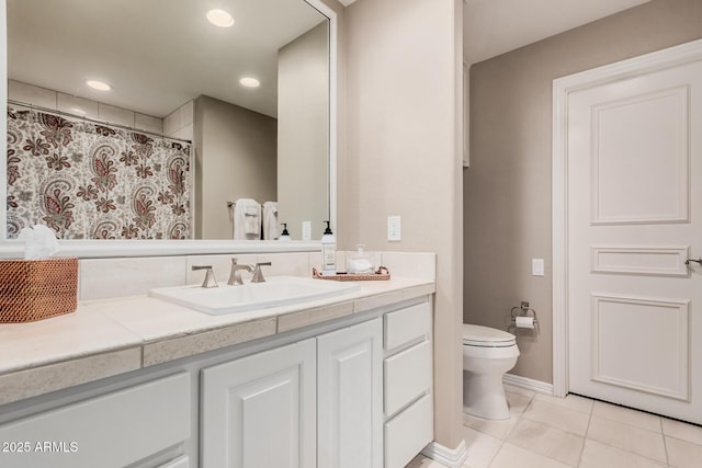 bathroom featuring tile patterned floors, vanity, and toilet