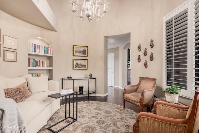 sitting room featuring wood-type flooring and an inviting chandelier