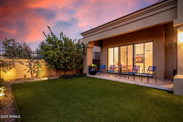 yard at dusk featuring an outdoor hangout area and a patio