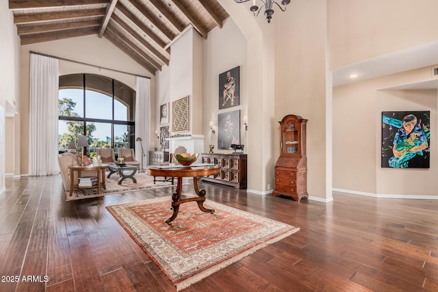 foyer featuring beamed ceiling, dark wood-type flooring, and high vaulted ceiling