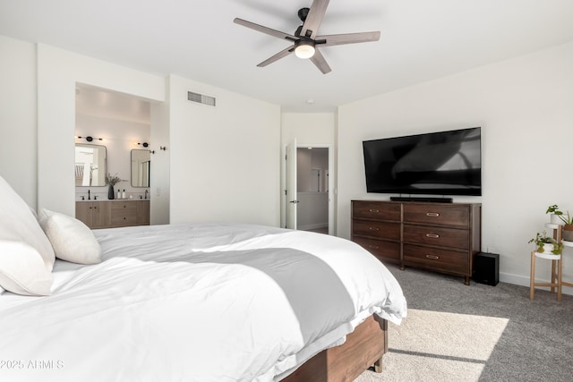 bedroom featuring ceiling fan, light colored carpet, and ensuite bathroom