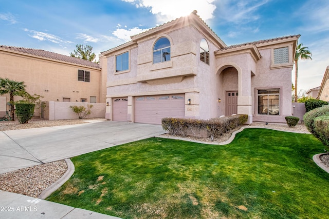 mediterranean / spanish house with a garage and a front yard