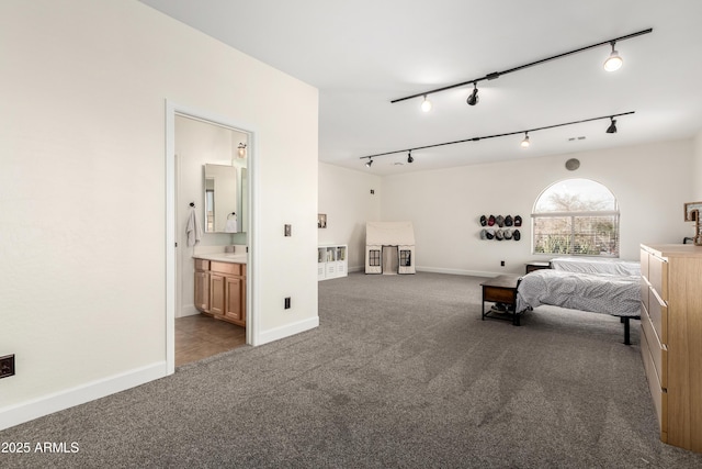 bedroom with light colored carpet and ensuite bath