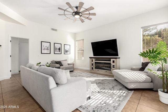 tiled living room featuring ceiling fan