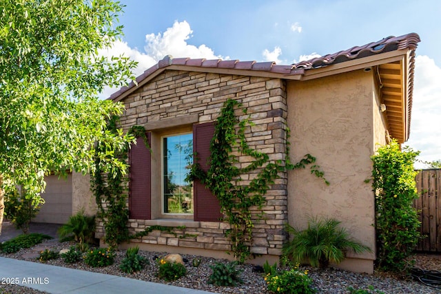 5328 S Wesley Cir, Mesa, AZ 85212 - view of side of property featuring a garage, stucco siding, stone siding, and a tiled roof