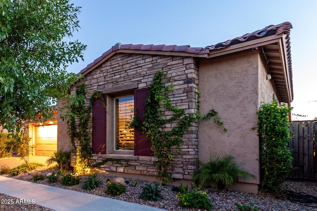 5328 S Wesley Cir, Mesa, AZ 85212 - view of home's exterior featuring stone siding, stucco siding, an attached garage, and a tiled roof