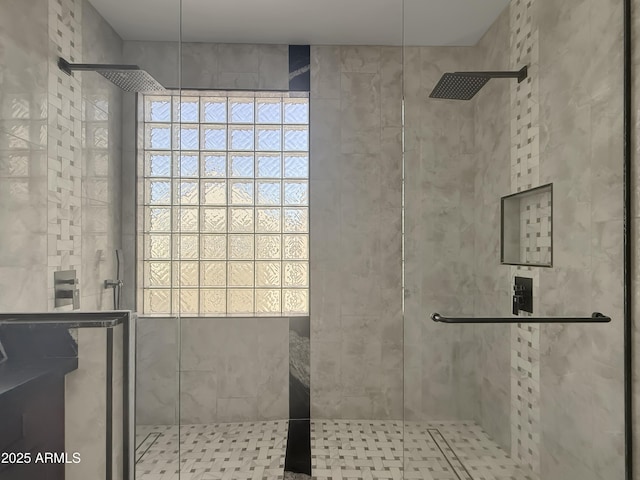 bathroom with a shower with door