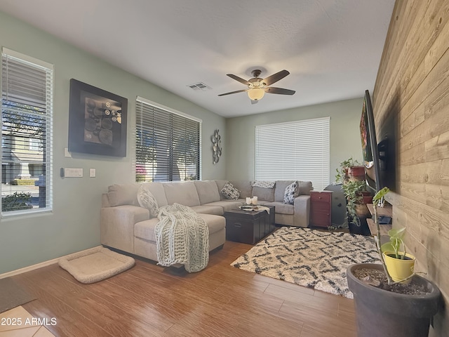 living room with hardwood / wood-style flooring and ceiling fan