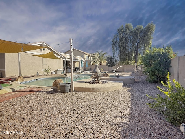 view of yard with a swimming pool with hot tub and a patio area