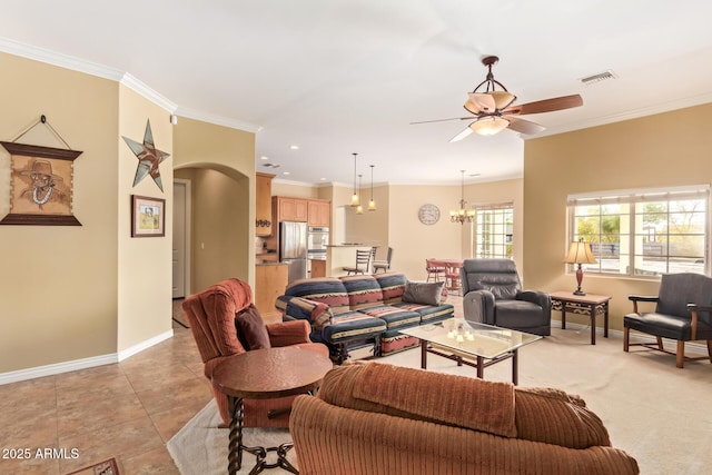 living area with baseboards, visible vents, arched walkways, and crown molding