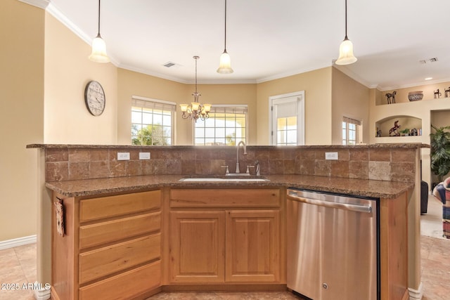 kitchen featuring dishwasher, a sink, visible vents, and crown molding