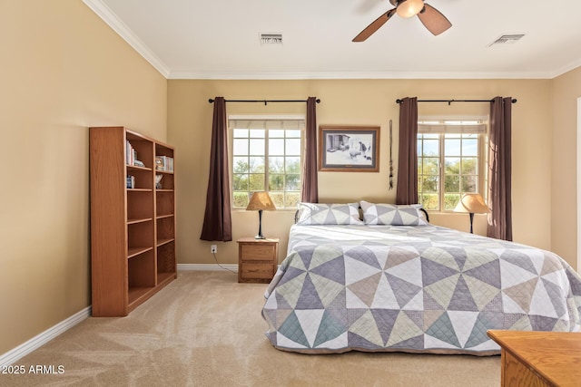 carpeted bedroom featuring ceiling fan, ornamental molding, visible vents, and baseboards