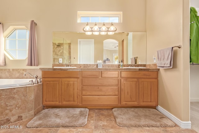 bathroom featuring double vanity, a garden tub, and a sink