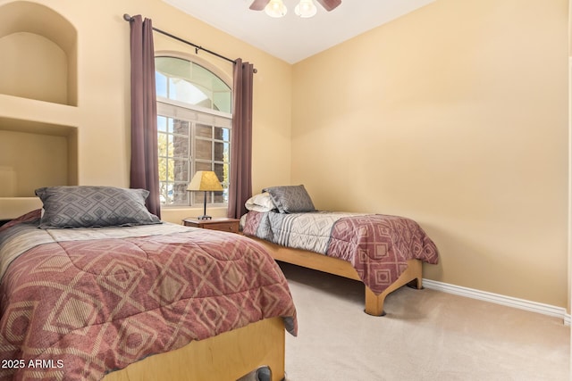 carpeted bedroom with a ceiling fan and baseboards