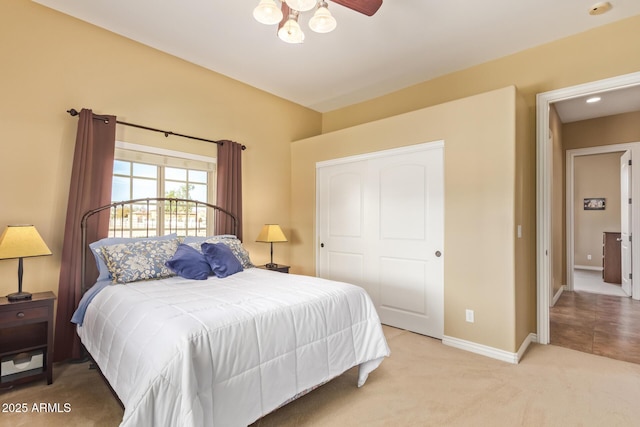 bedroom with a closet, carpet flooring, and baseboards