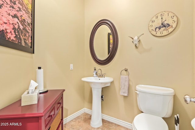 bathroom featuring tile patterned floors, toilet, and baseboards