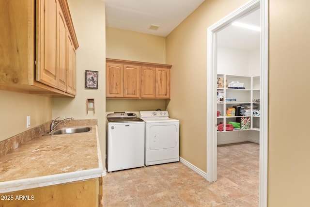 laundry area with separate washer and dryer, a sink, visible vents, baseboards, and cabinet space