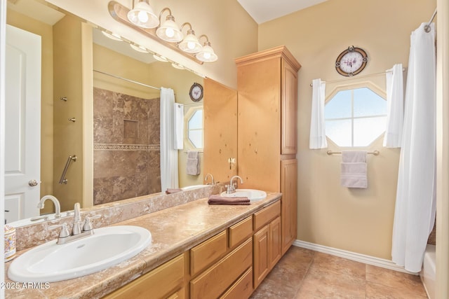 full bathroom featuring double vanity, curtained shower, a sink, and baseboards