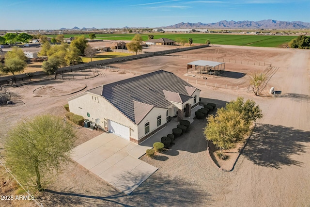 birds eye view of property featuring a mountain view and a rural view