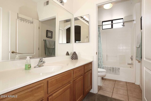 full bathroom with shower / tub combo, tile floors, oversized vanity, and toilet