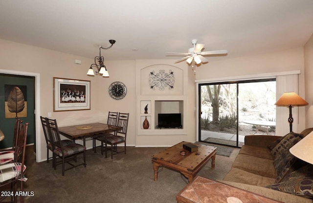 carpeted living room featuring ceiling fan with notable chandelier