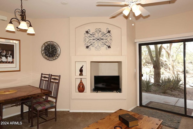 living room featuring dark colored carpet and ceiling fan with notable chandelier