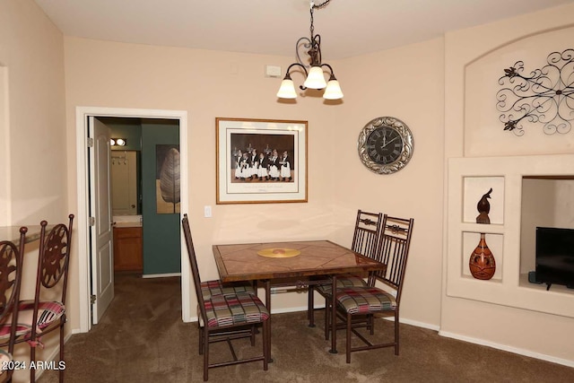 dining room featuring an inviting chandelier and dark carpet