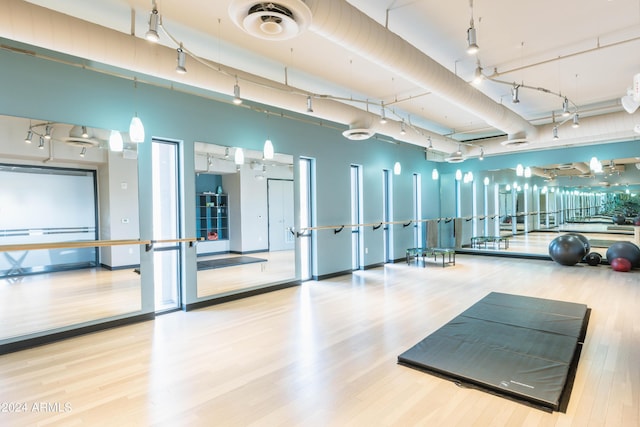 exercise room with hardwood / wood-style floors