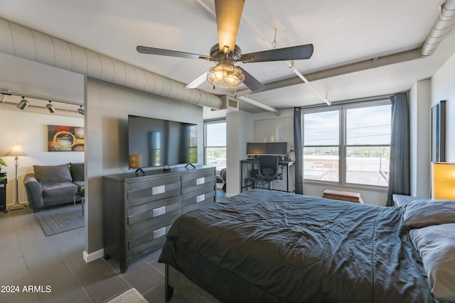 bedroom with ceiling fan and multiple windows