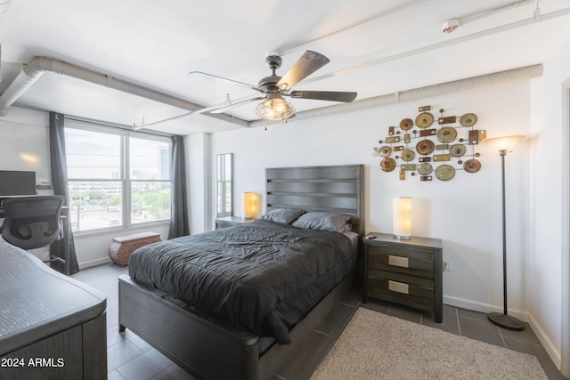 tiled bedroom featuring ceiling fan