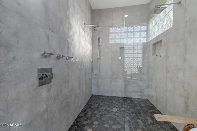 bathroom with plenty of natural light and a tile shower