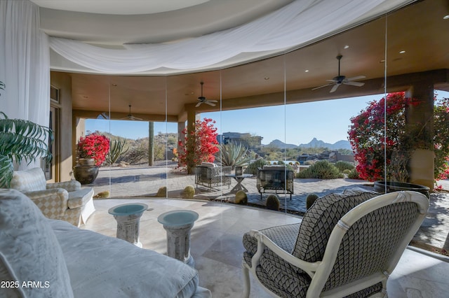 view of patio featuring ceiling fan and a mountain view