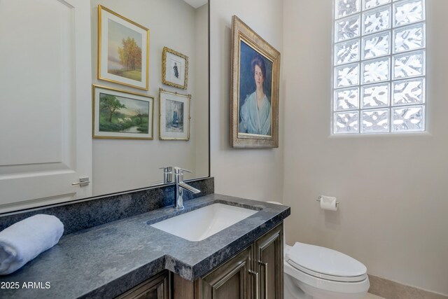 bathroom featuring vanity and toilet