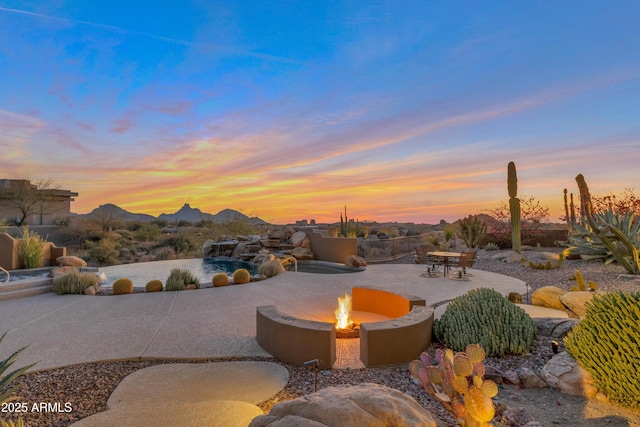 exterior space featuring a mountain view and an outdoor fire pit