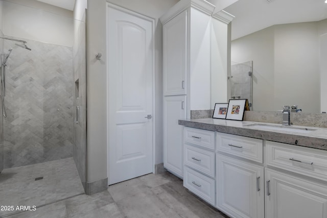 bathroom featuring vanity and a tile shower