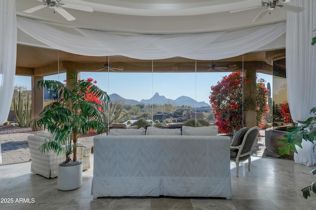 living room featuring ceiling fan, floor to ceiling windows, and a mountain view