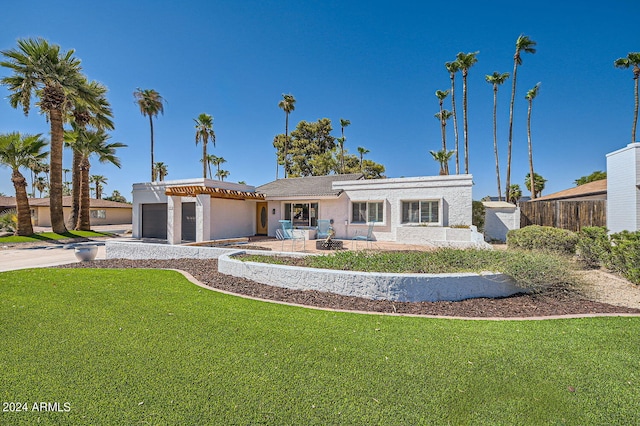 view of front of property with a patio and a front lawn