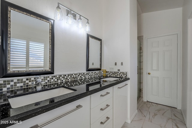 bathroom featuring vanity and tasteful backsplash