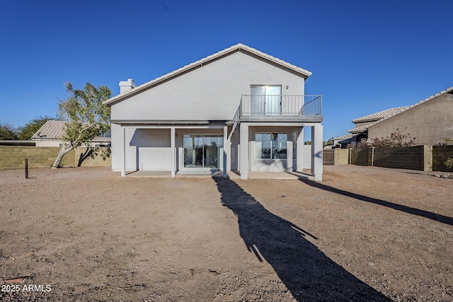 back of house featuring a patio area and a balcony