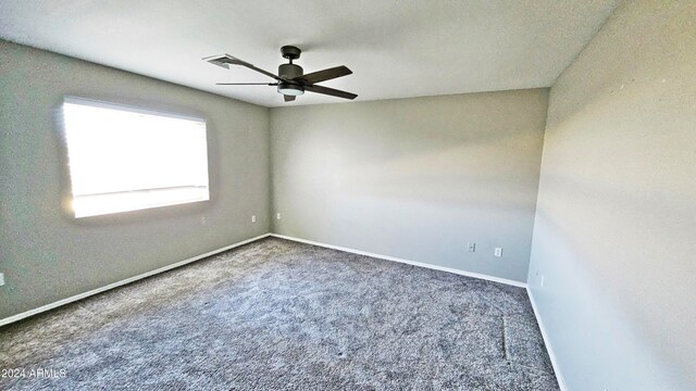 carpeted spare room featuring ceiling fan