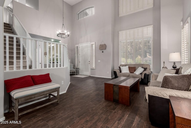 6862 W Honeysuckle Dr, Peoria, AZ 85383 - living area with a towering ceiling, a chandelier, dark wood finished floors, stairway, and baseboards
