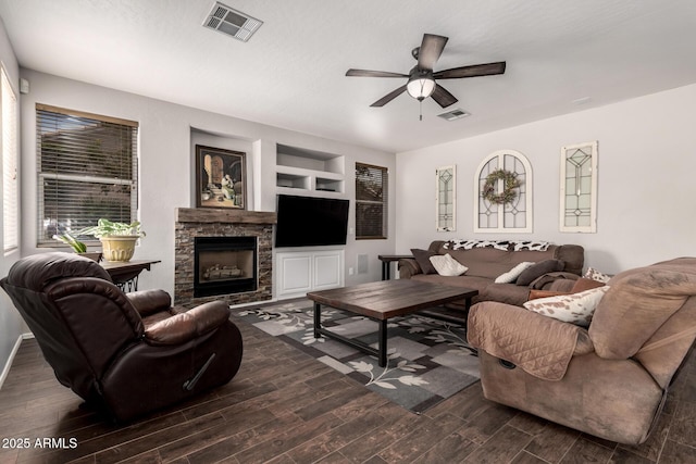 6862 W Honeysuckle Dr, Peoria, AZ 85383 - living area with ceiling fan, dark wood-style floors, a fireplace, and built in shelves