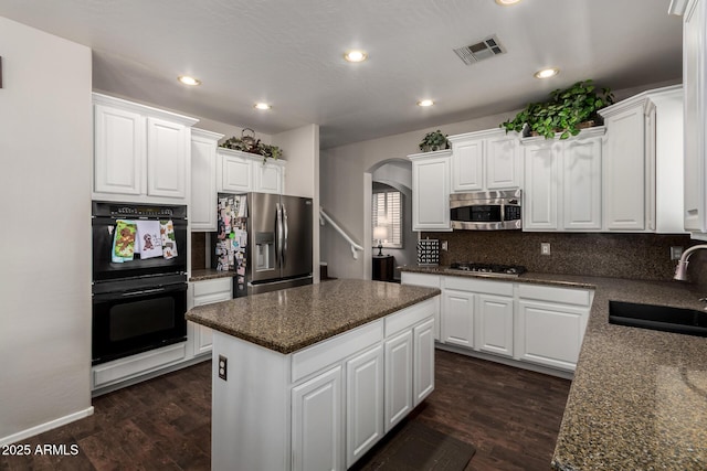 6862 W Honeysuckle Dr, Peoria, AZ 85383 - kitchen featuring a sink, stainless steel appliances, arched walkways, a kitchen island, and recessed lighting